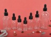 Clear essential oil glass bottle with black dropper