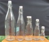 Glass bottle for fruit juice or milk with metal clip