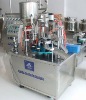 Soft tube filling and sealing machine