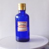 blue essential oil bottle with metal cap