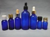 blue essential oil bottle with metal cap