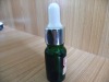 dark green essential oil bottle with white rubber dropper