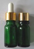 green essential glass bottle