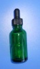 green glass essential oil bottle