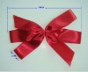 red satin ribbon bow used in gift packaging