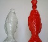 red, transparent, fish shaped glass wine bottle