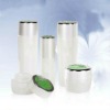 white cosmetic bottle and cream jar with silver cap